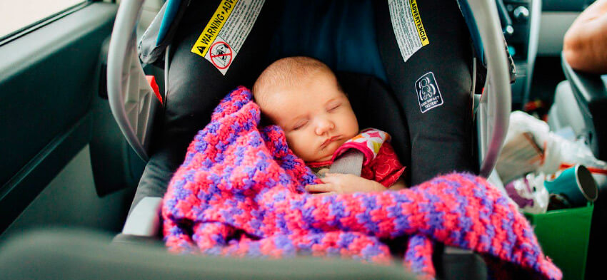 Ребенок сладко спит в автокресле